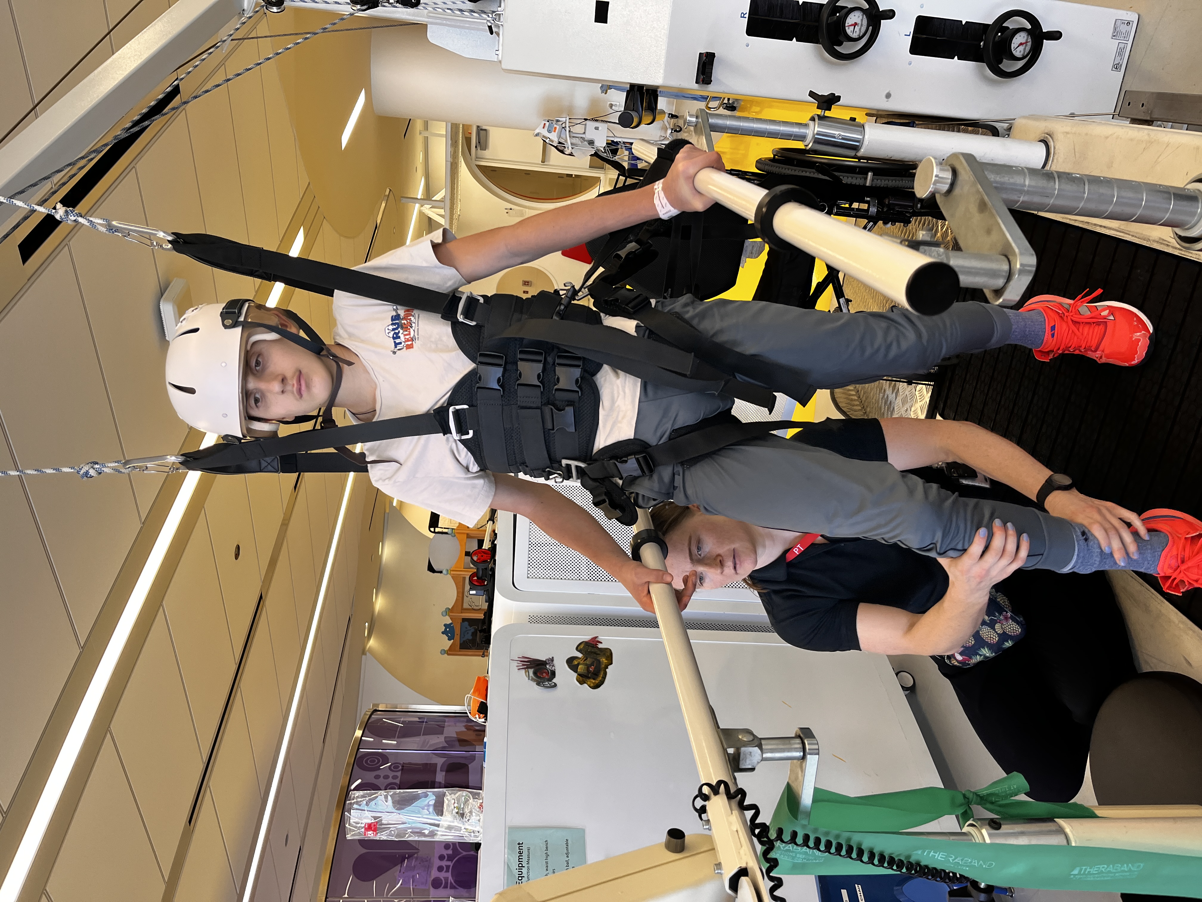 Kellan suspended in a harness