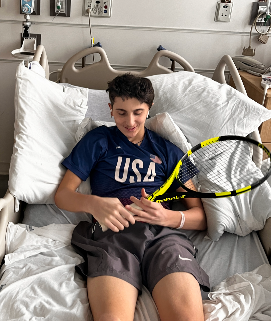 Kellan holding tennis racquet