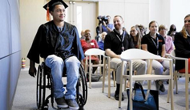 GED Graduate Leomar Leyva comes down the aisle to recieve his diploma.