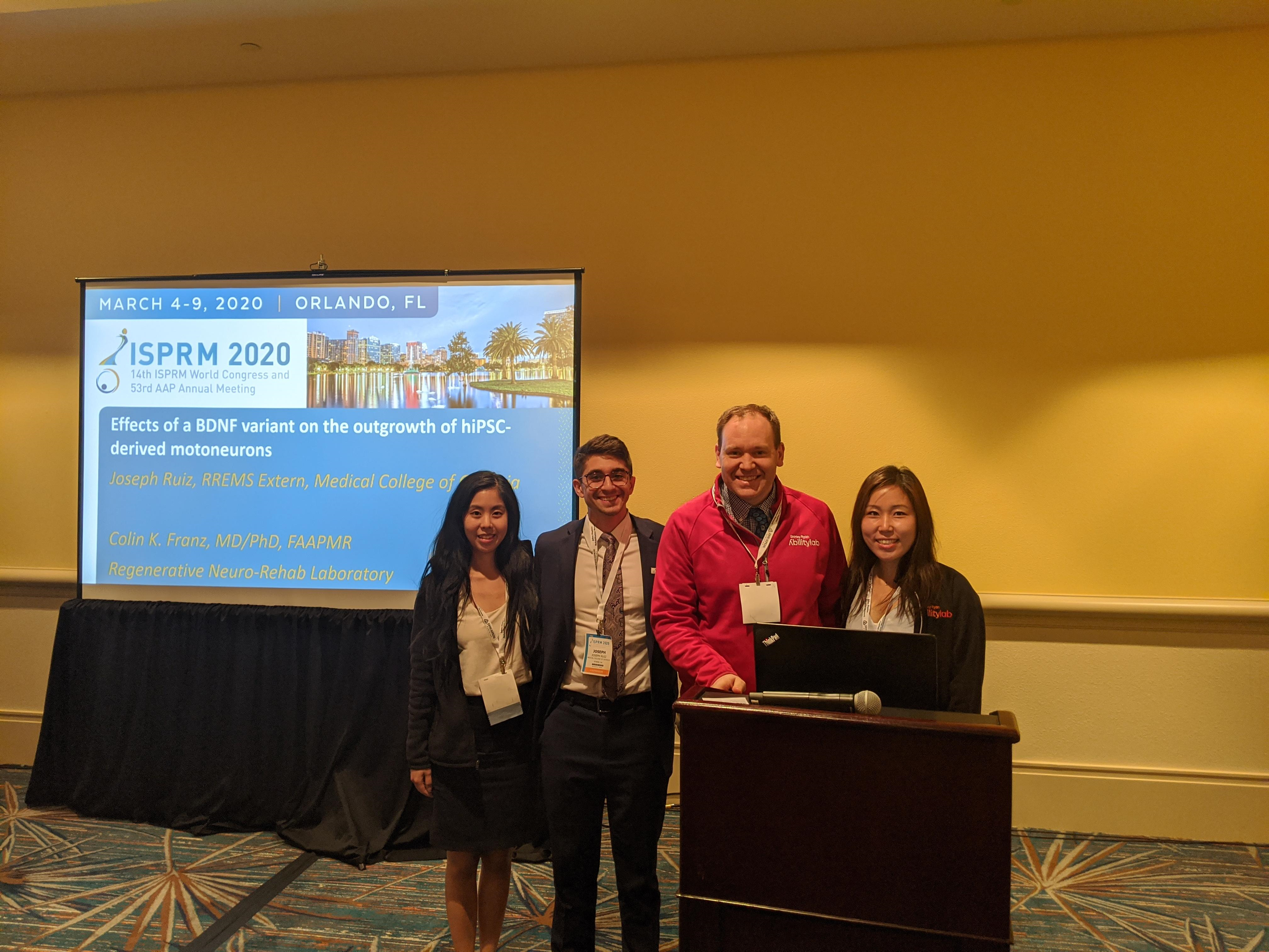Dr Leung, Dr Ruiz, Dr Franz, and Dr Lee stand together at a conference podium