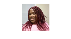 This is a picture of Latoya Maddox. She is a black woman who is wearing a pink shirt and has pink braided hair.