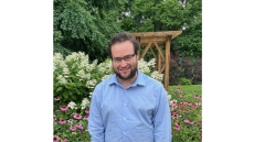 Scott Roiter stands in front of foliage