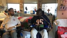 two men in wheelchairs in a hospital room