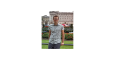 young man in front of European buildings