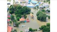 photo of block that has been flooded. Tops of tree and roofs are showing