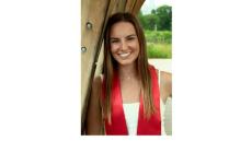 photo of Lorie Cashdollar, a young white woman with straight long brown hair wearing a red graduation sash