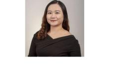 Color photo of Melody Yang, a young Asian woman with black hair and a black top