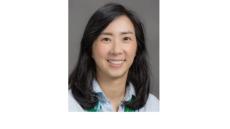 Color photo of Danbi Lee, a young Asian woman with shoulder length black hair wearing a light blue button down shirt