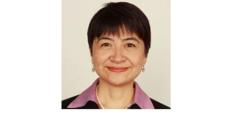 Color photo of Cindy Cai, a middle aged Chinese woman with short black hair wearing a pink blouse under a black blazer