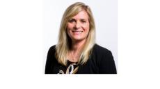 Color photo of Deborah Crown, a middle aged white woman with long blonde hair wearing a black top