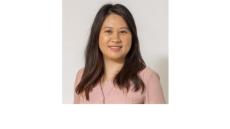 Color photo of Manrui Zhang, a young Chinese American woman with shoulder lengths black hair wearing a pink blouse