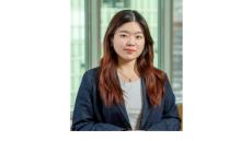 color photo of Weiwei Li, a young Chinese student with long brown hair wearing a gray t shirt and denim blazer
