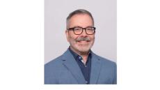 Photo of Roberto López-Rosado, PT, DPT a middle aged man with a black beard and glasses wearing a blue siut