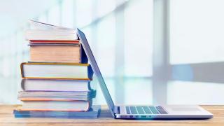 Stack of books and laptop