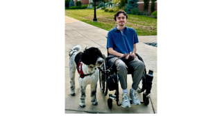 Steph with his service dog, Noel