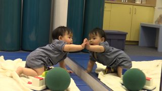 Baby Touching Hand to Mirror