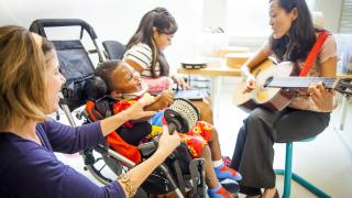 Music therapist works with a pediatric patient