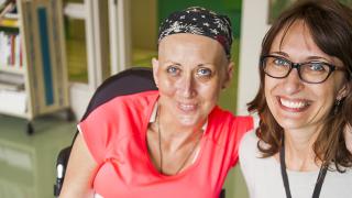 Cancer survivor smiling with her physician