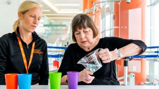 therapist and patient doing fine motor therapy with hands and arms