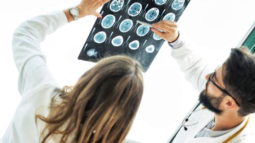 physiatrists looking at an image of a patient brain scan