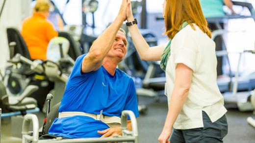 photo of patient and therapist giving a high-five 