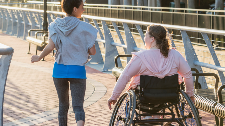 Wheelchair user exercising with their friend 