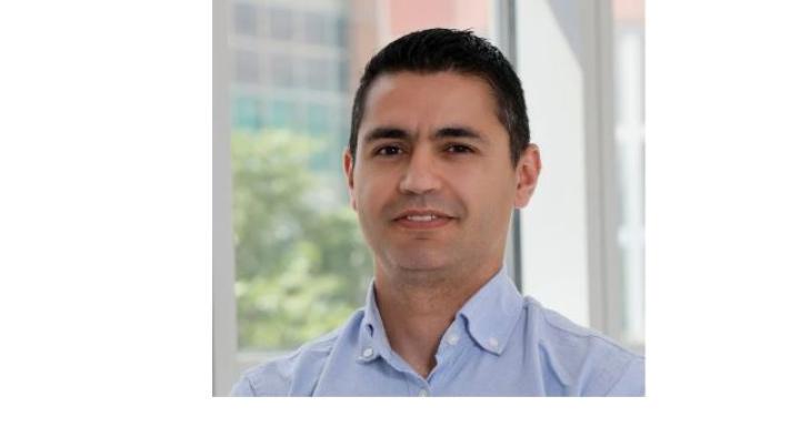 color photo of Tiago Jesus, a young Portuguese man with black hair wearing a button down 