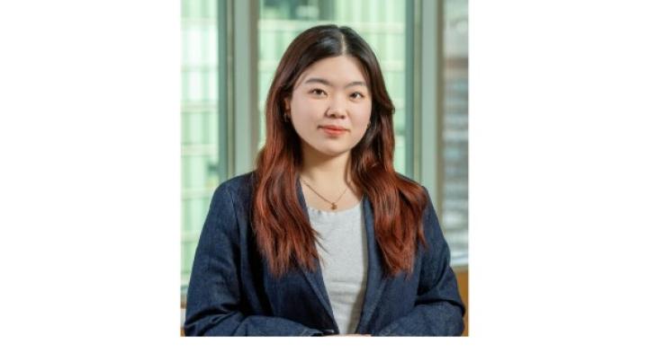 color photo of Weiwei Li, a young Chinese student with long brown hair wearing a gray t shirt and denim blazer