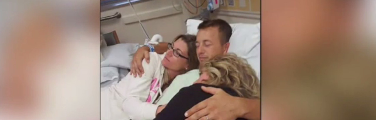 Cole hugs his family while recovering from the SCI