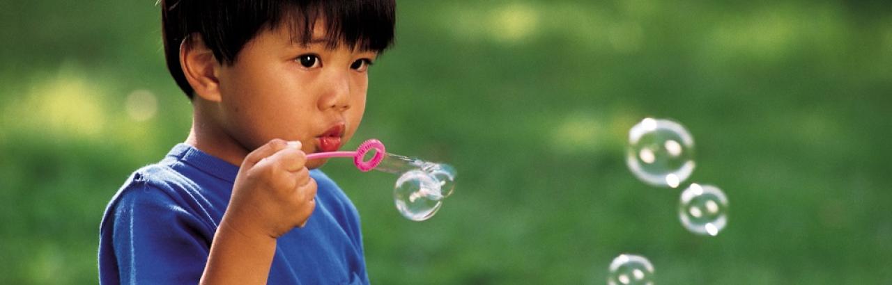 boy blowing bubbles