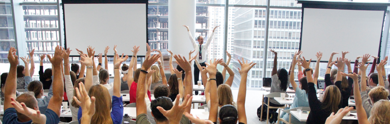 learners at an Academy course raising their hands 