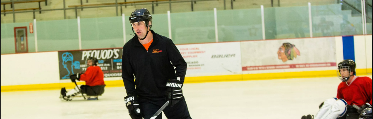 derek Daniels playing hockey with the adaptive hockey team