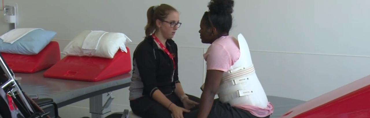 paralyzed patient from Peoria working with her physical therapist