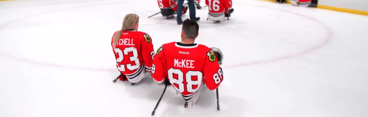 kevin and Erica on the ice after Blackhawks sled hockey game