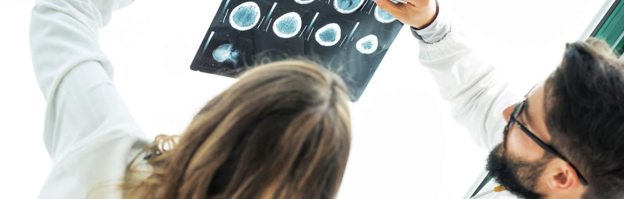 physiatrists looking at an image of a patient brain scan