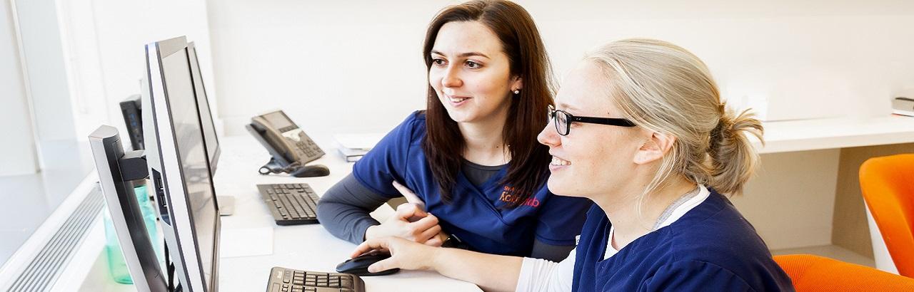 Two Shirley Ryan AbilityLab employees at a computer