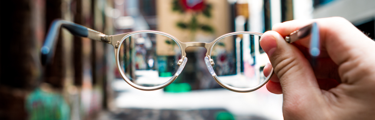 blurry street and glasses in focus