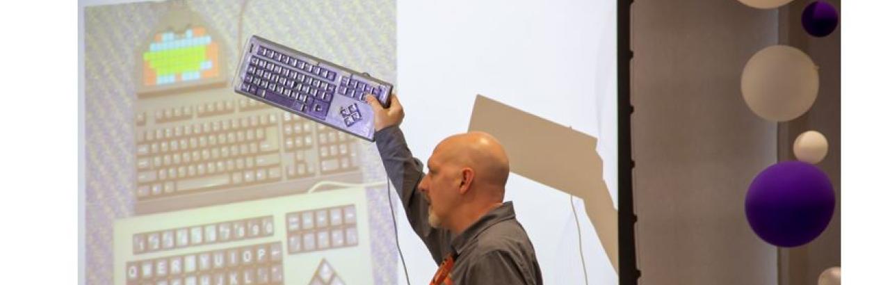 SRAlab senior therapist Ed Hitchcock, OT/L holding an adaptive keyboard.