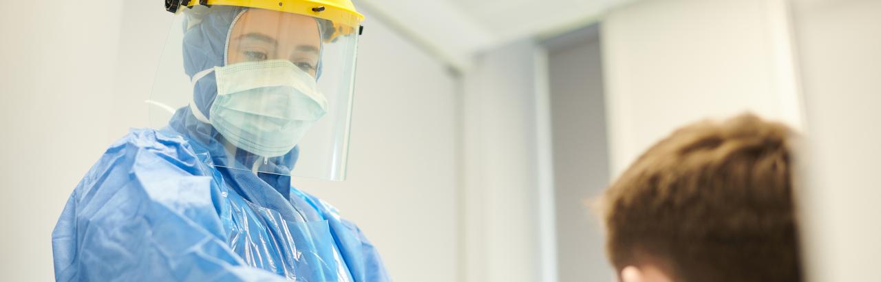 Doctor in PPE taking care of patient