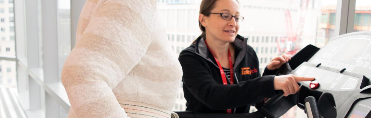 Miriam Rafferty assists patient on Muscle and Strength Lab