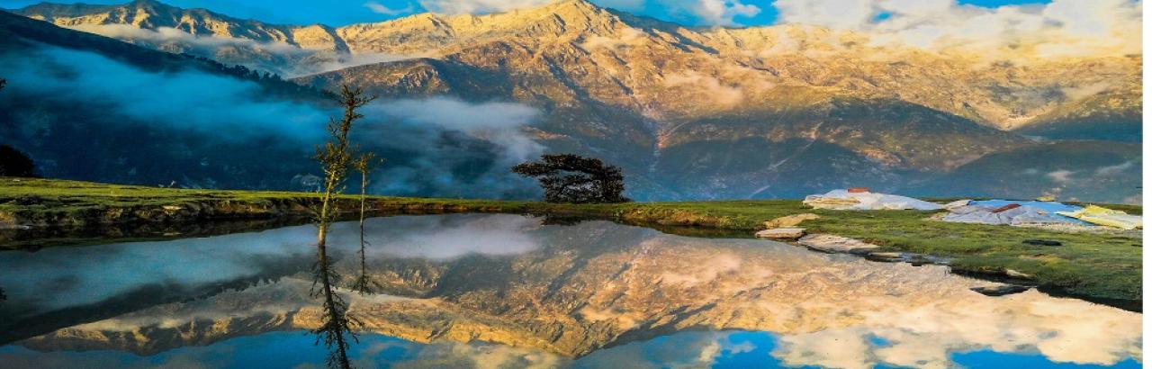 mountains with peach clouds reflected in water