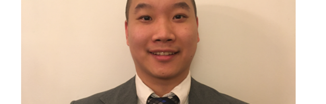 A picture of Rudy Chiu wearing a great suit, white dress shirt, and navy tie.