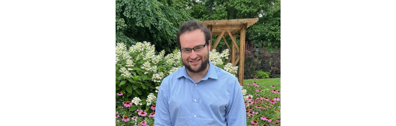 Scott Roiter stands in front of foliage