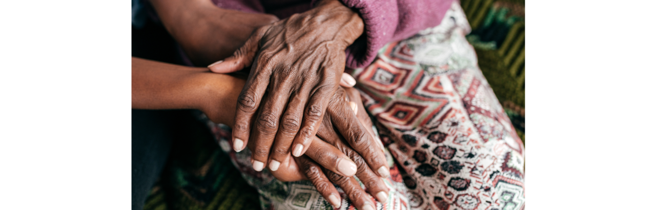 Image of senior hands being held