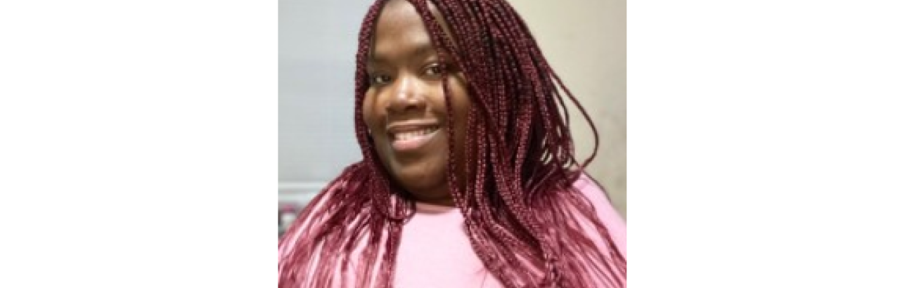 young black woman with pink top and pink braids, smiling