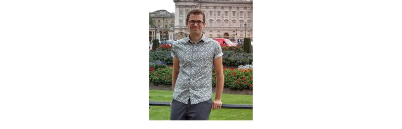 young man in front of European buildings