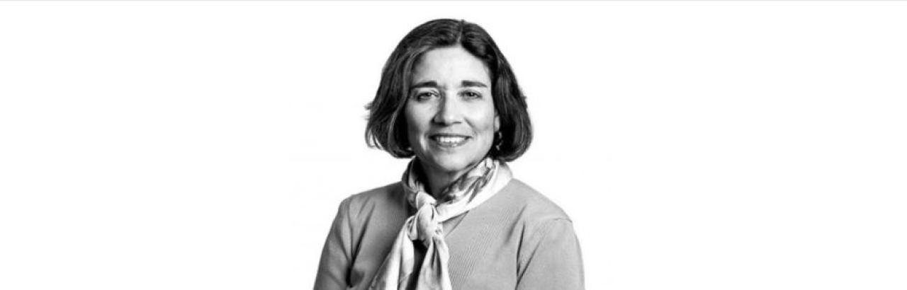 Black and white portrait of a white woman with short black hair smiling.