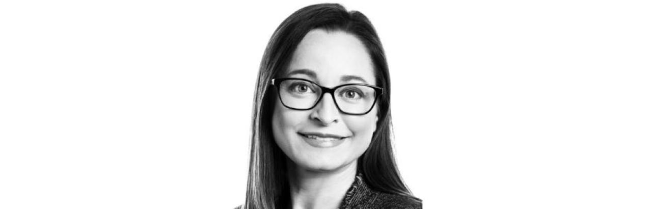 Black and white portrait of a white woman with short black hair smiling.