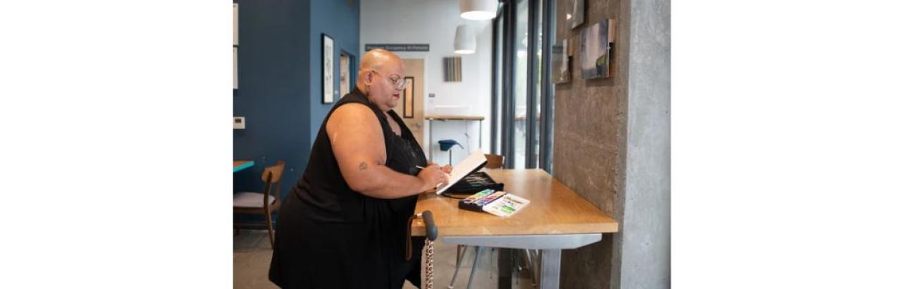 photo of a black woman at a standing desk