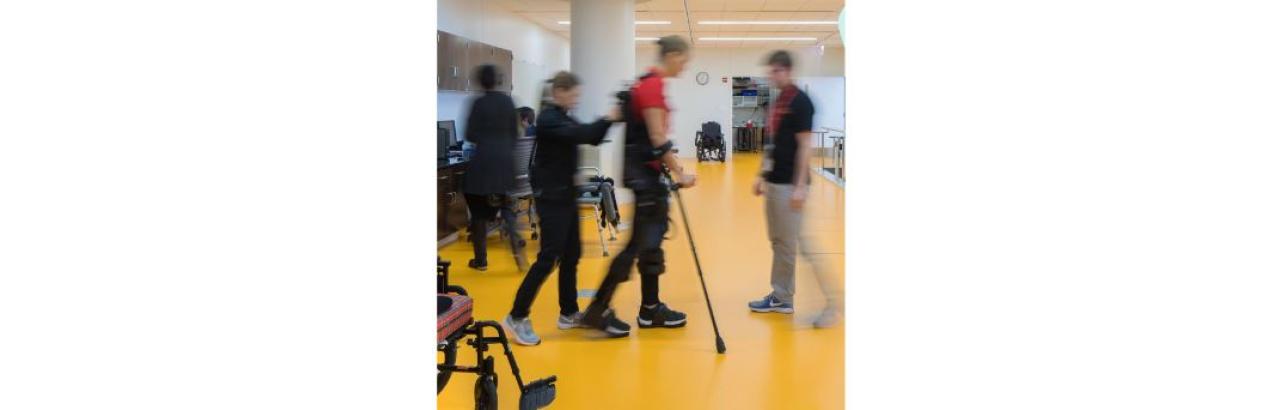 a blurred photo of a patient being helped to talk by a rehabilitation therapist